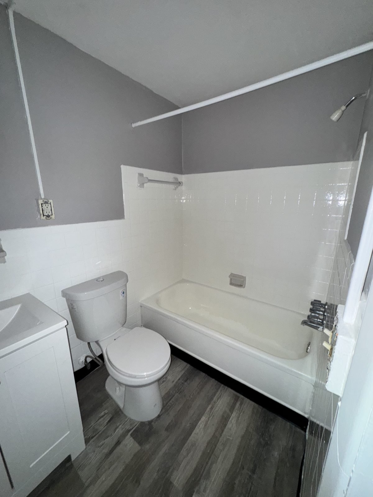 Bathroom after: new tub surround, vanity and flooring