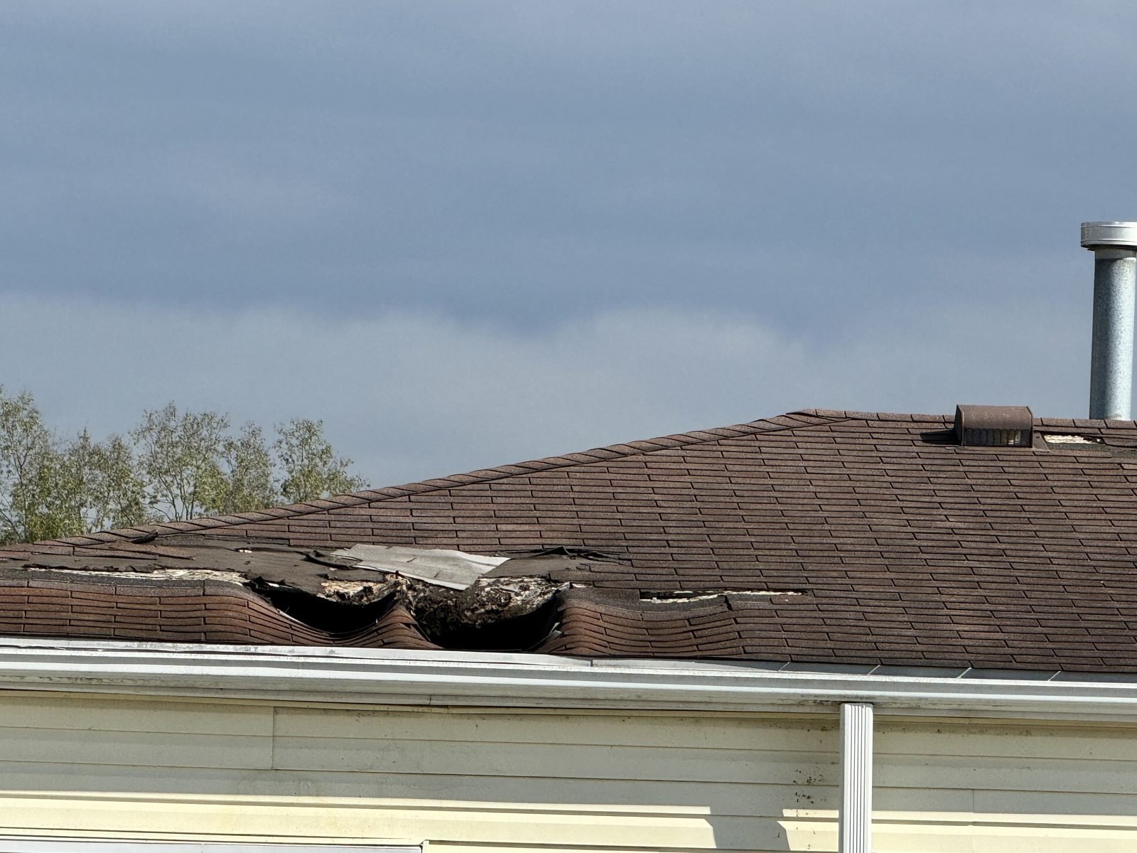 Roof before: torn and missing shingles
