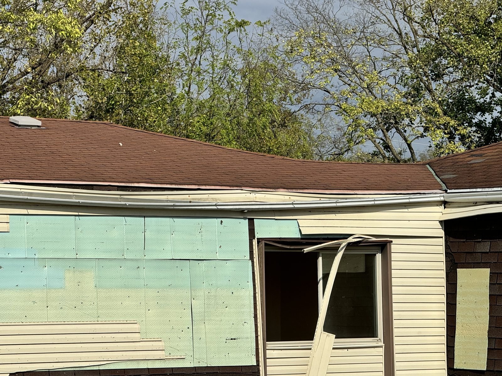 Building before: roof and wall opened up, sheathing exposed