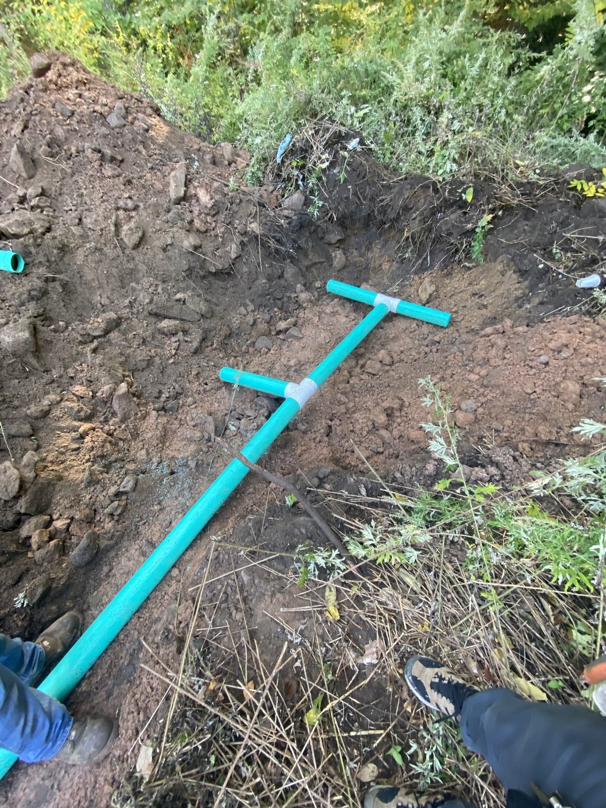 Septic install: tank riser and new distribution lines in the open trench